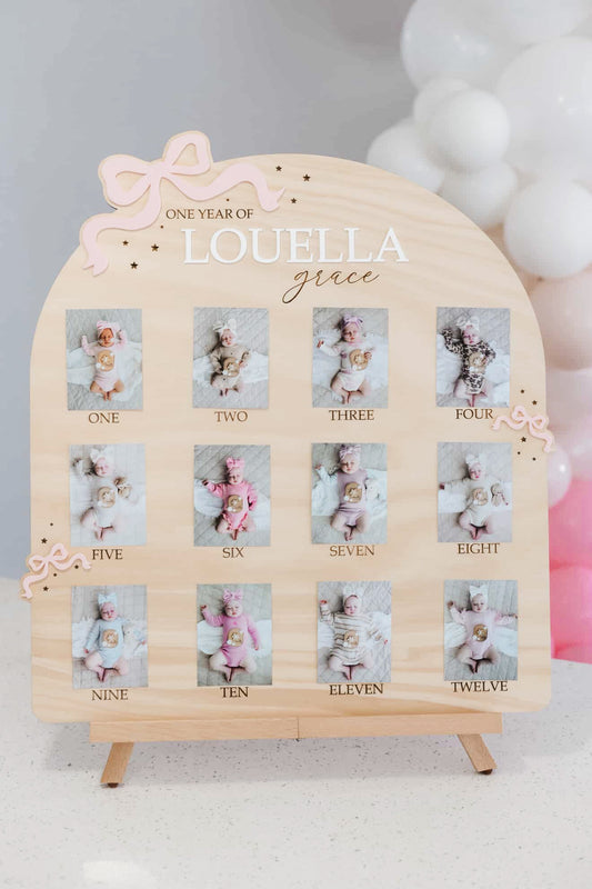 Bow theme first birthday photo board
