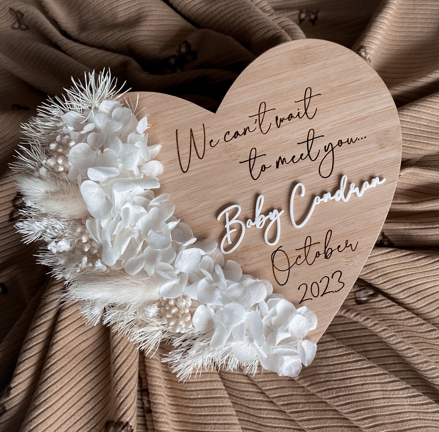 We can’t wait to meet you dried floral heart pregnancy announcement