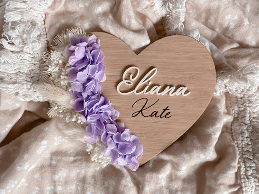 Dried floral white and purple heart announcement