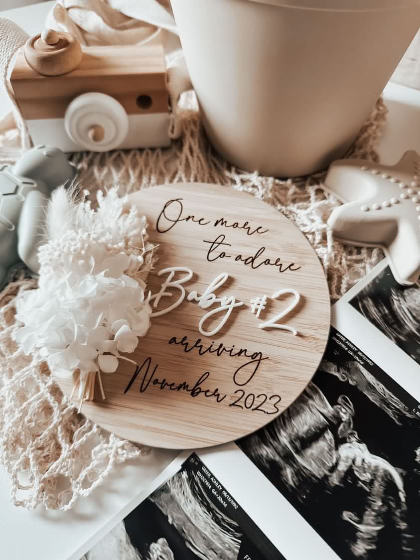 One more to adore pregnancy announcement sign