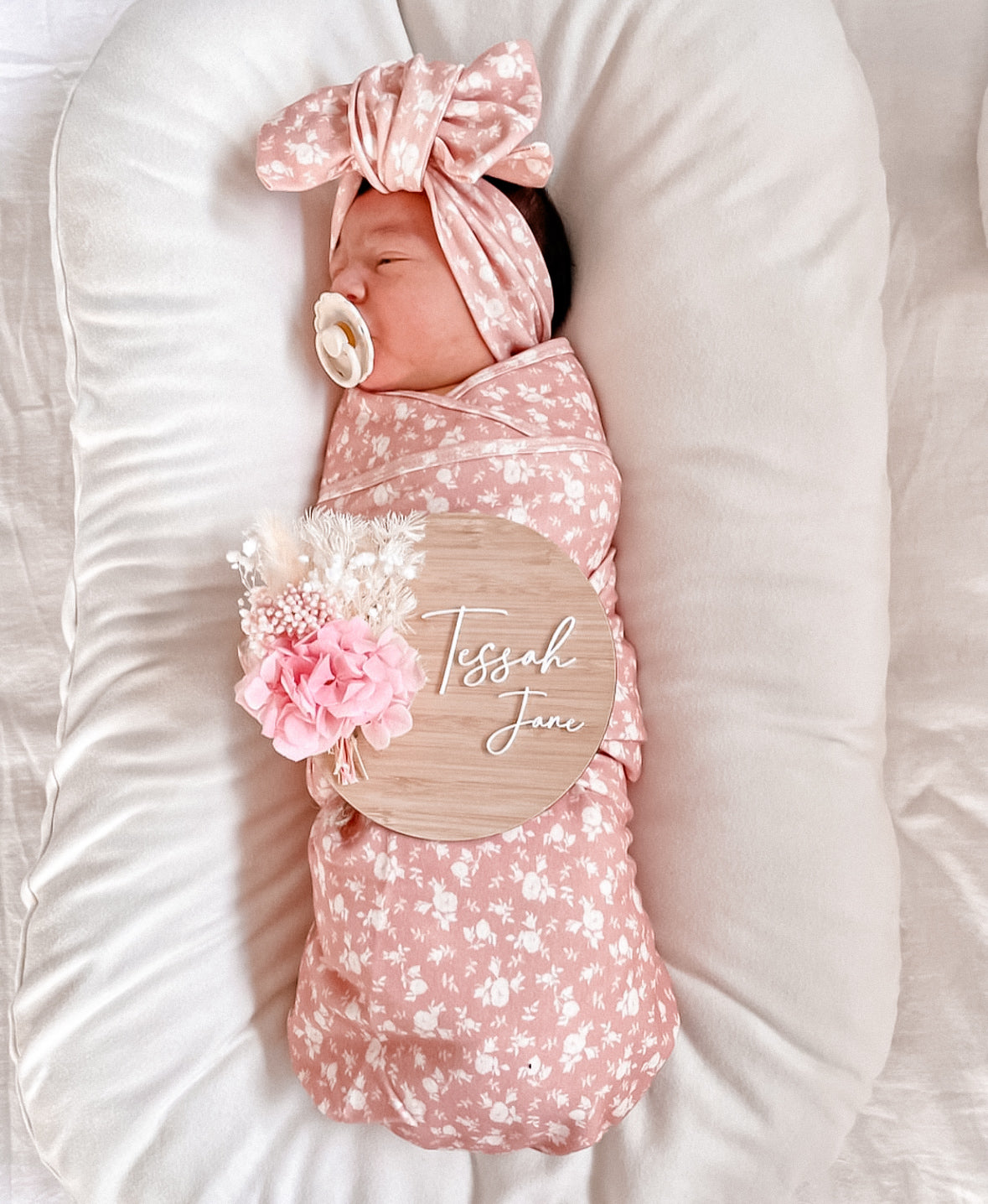 Bright pink and white dried flower baby name sign