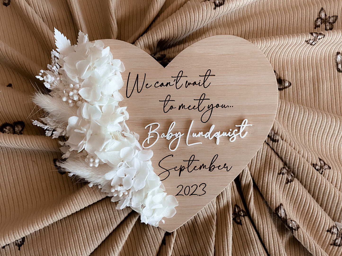 We can’t wait to meet you dried floral heart pregnancy announcement