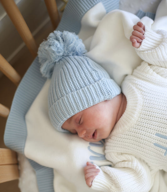 Blue knit pompom newborn hat