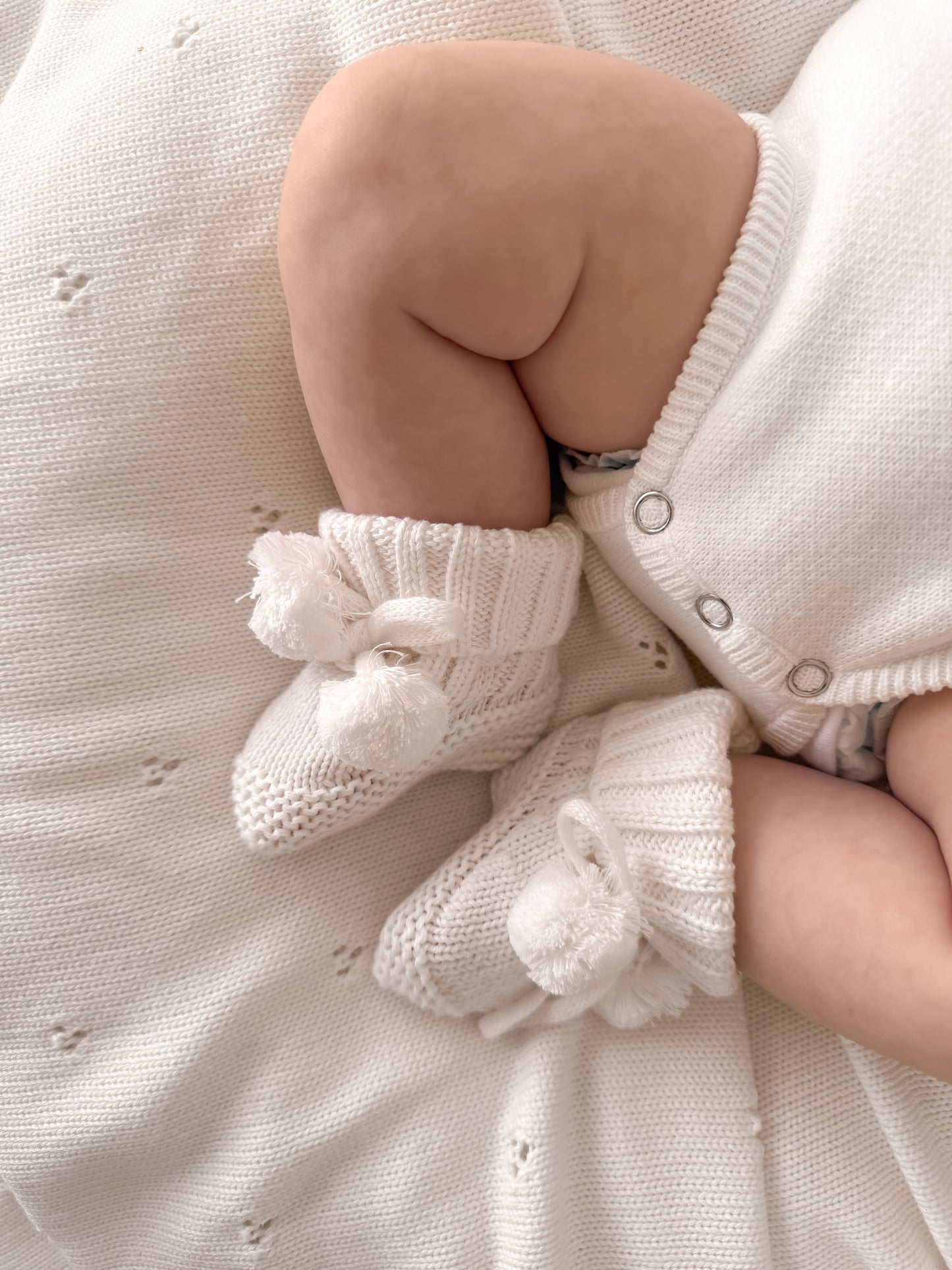 White soft knit pompom baby booties