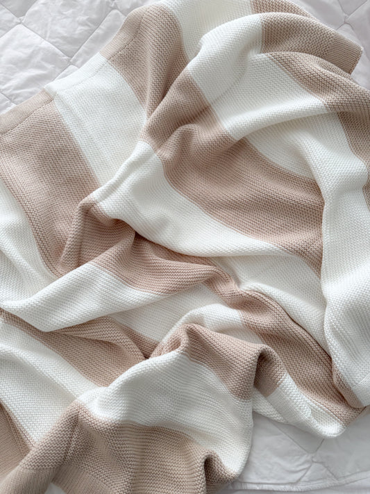 White and oatmeal knit stripe blanket